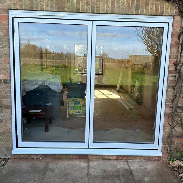 White aluminium sliding patio doors overlooking a garden