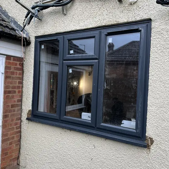 Anthracite grey casement window on a white rendered wall