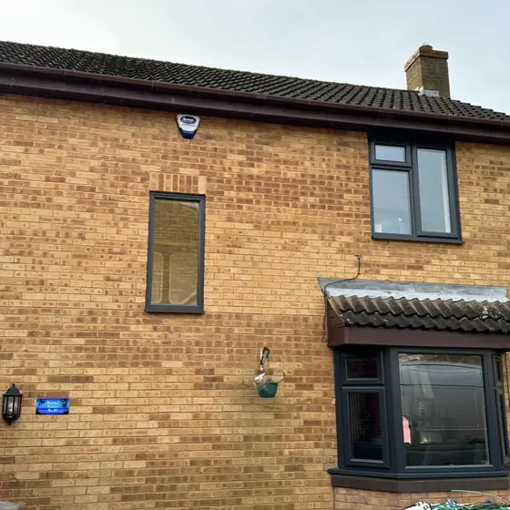 Yellow brick house fitted with anthracite grey windows