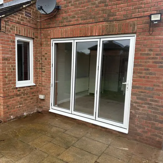 White French doors with side panels onto a paved patio