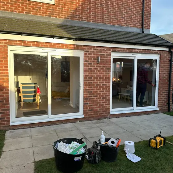 Two sets of white sliding doors on a single-storey rear extension