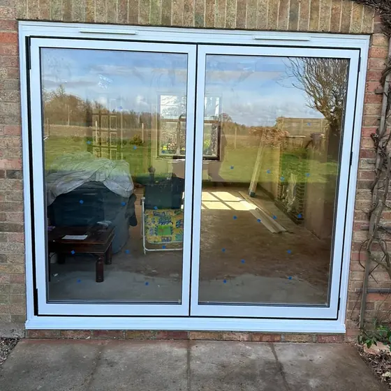 White sliding patio doors looking out over a garden