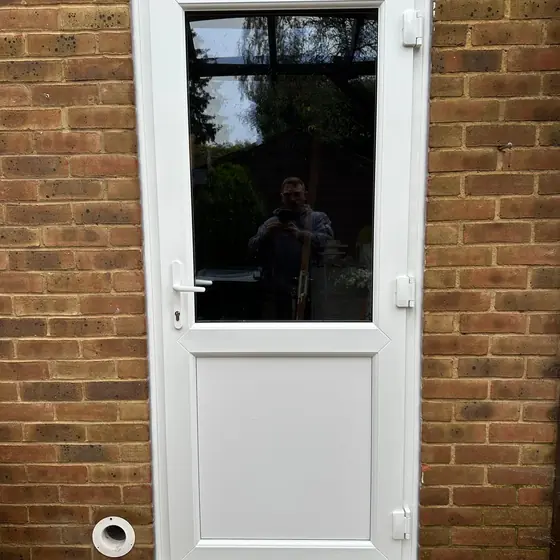 White uPVC back door with a glazed top half on a brick house