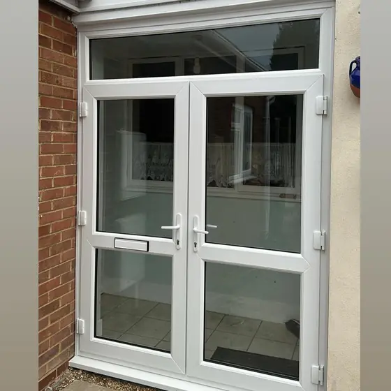 White uPVC French doors with a glazed side panel and top light