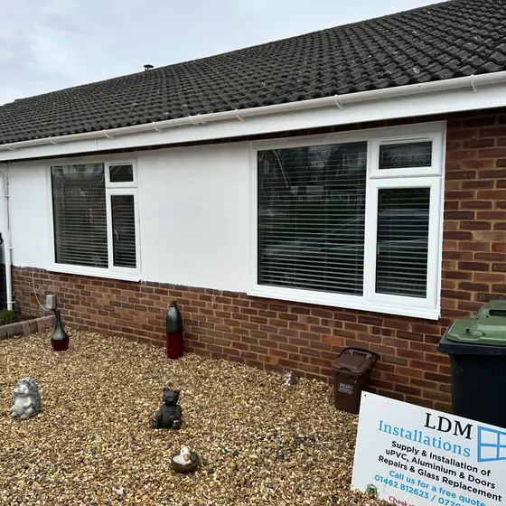 Bungalow with new white uPVC windows and an LDM Installations sign