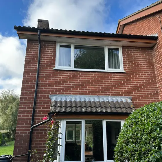 Semi-detached brick house with new white uPVC windows upstairs and down