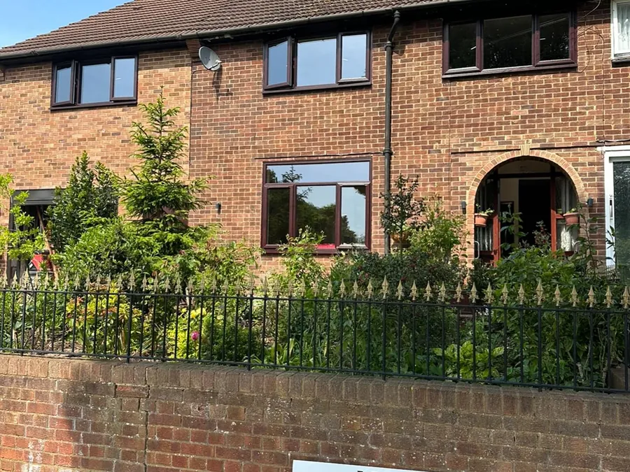 Semi-detached home with newly replaced windows and an LDM Installations sign board outside